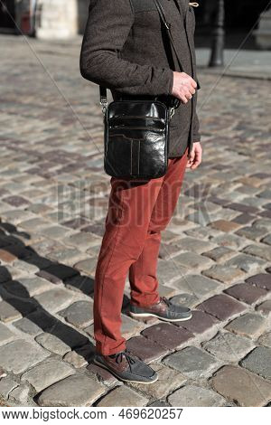 Close-up Photo Of Black Messanger Leather Bag On Mans Shoulder