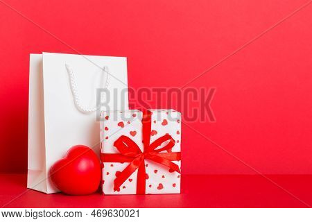 Shopping Bag With Gift Box On Colored Background Perspecrive View. Space For Text Holiday Concept.
