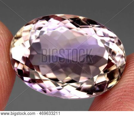 Natural Gemstone Bicolor Ametrine On A Gray Background
