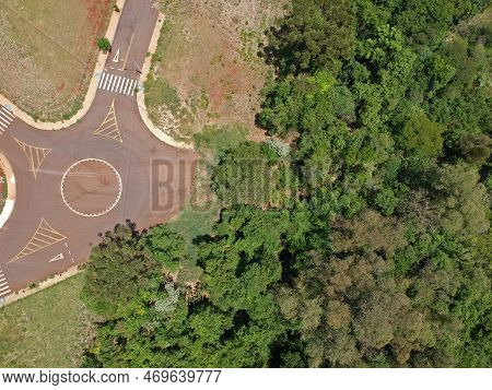 Aerial Drone Photo Of A Beautiful Forest Next To The Streets Of A City