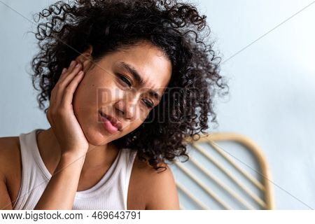 Young Multiracial Woman Touching Ear In Pain. Latina Female Suffering From Otitis. Body Care Concept