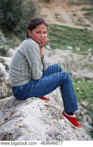 Tunisia - March 16, 2007. Muslim Girl, A Young Berber Shepherdess Girl Watches Over Her Family's Goa