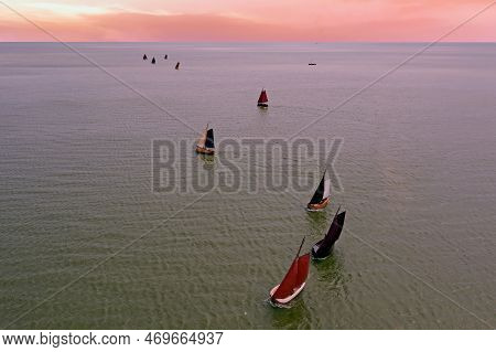 Aerial From Traditional Dutch Wooden Boats At The Ijsselmeer Near The Harbor From Laaxum In Frieslan