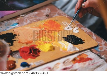 Close-up Of Painter Combine Colours On Palette. Creamy Oil Paints On Surface. Painter Equipment For 