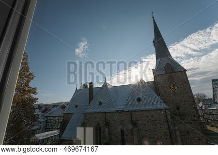 An Old German Church On A Sunny Winter Day, View From The Window Of A Neighboring House