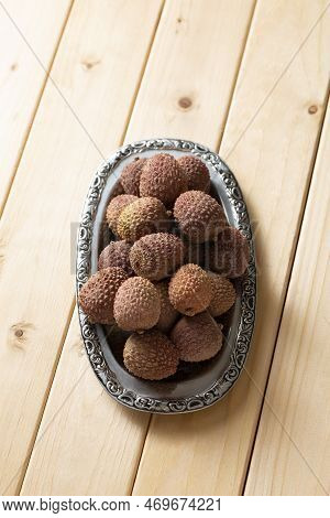 Bunch Of Lychee Fruit In A Metal Plate, On A Wooden Table, Close-up