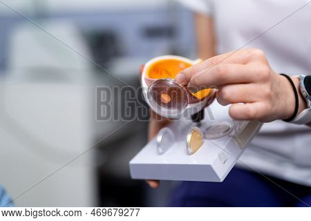 Ophthalmologist Or Surgeon Holds An Eye, Eyeball Prosthesis In Hands . Concept Photo For Ocular Pros