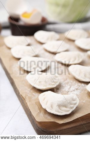 Raw Dumplings (varenyky) With Tasty Filling On White Wooden Table, Closeup