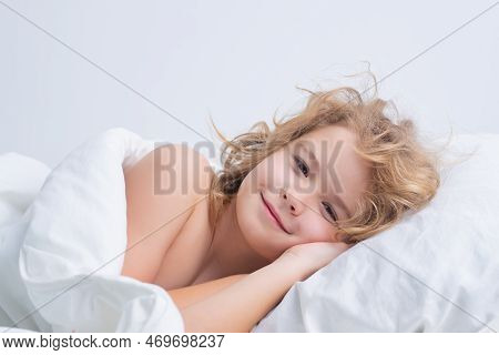 Quietly Sleeping. Child Wakes Up In The Morning In The Bedroom. Cute Little Boy Waking Up In Bed.