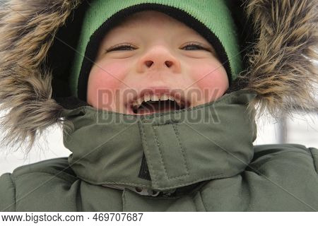 Happy Kid Having Fun On Carousel. Front View Of Smiling Little Boy Enjoying An Merry-go-round Attrac