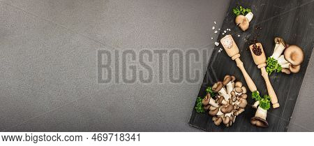 Delicious Organic Oyster Mushrooms With Spices And Fresh Parsley On Wooden Cutting Board