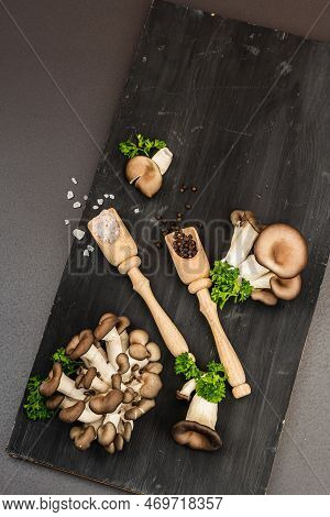 Delicious Organic Oyster Mushrooms With Spices And Fresh Parsley On Wooden Cutting Board