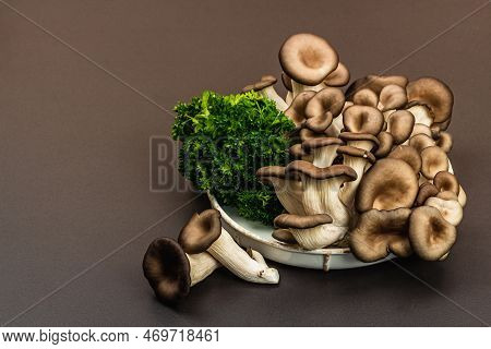 Delicious Organic Oyster Mushrooms With Fresh Parsley. Source Of Beta Glucan, Black Stone Background