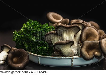 Delicious Organic Oyster Mushrooms With Fresh Parsley. Source Of Beta Glucan, Black Stone Background