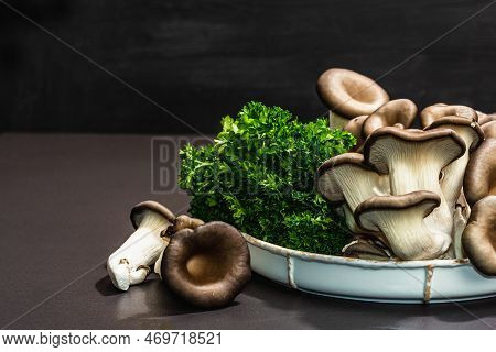 Delicious Organic Oyster Mushrooms With Fresh Parsley. Source Of Beta Glucan, Black Stone Background