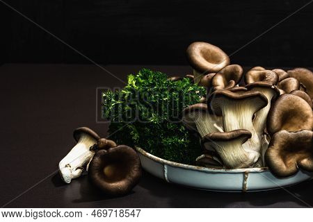 Delicious Organic Oyster Mushrooms With Fresh Parsley. Source Of Beta Glucan, Black Stone Background