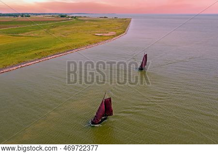Aerial From Traditional Dutch Wooden Boats At The Ijsselmeer Near The Harbor From Laaxum In Frieslan