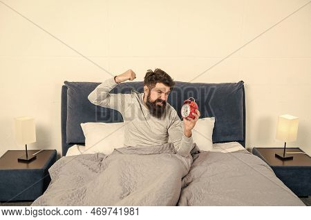 Angry Man Figting With Alarm Clock Being In Bed In Morning, Overslept