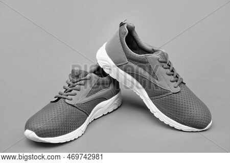 Sporty Blue Sneakers Pair On Orange Background, Jogging Shoes