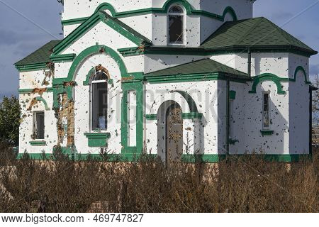 Countryside. Damaged after the shelling of the Orthodox Church. Holes from bullets and shrapnel in t