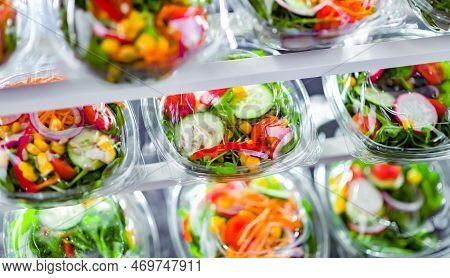 Boxes With Pre-packaged Vegetable Salads In A Commercial Fridge