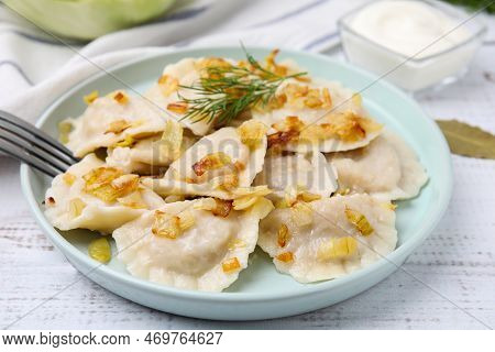 Cooked Dumplings (varenyky) With Tasty Filling, Fried Onions And Dill On Wooden Table, Closeup