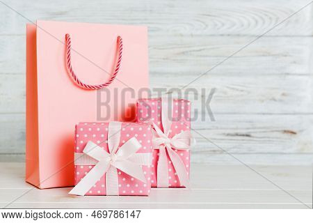 Shopping Bag With Gift Box On Colored Background Perspecrive View. Space For Text Holiday Concept.