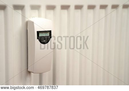 Heat Consumption Meter On The White Radiator. Close Up.