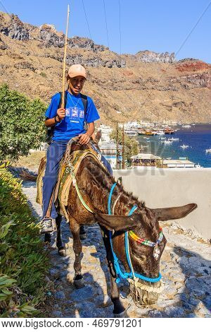 Thirasia, Greece - September 29, 2011: View Of A Local Donkey Handler And His Donkey, In The Aegean 