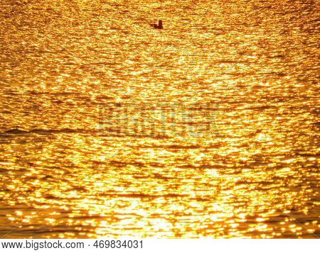 An Amazing Shot Of A Calm Blue Sea On Orange Sunset Background