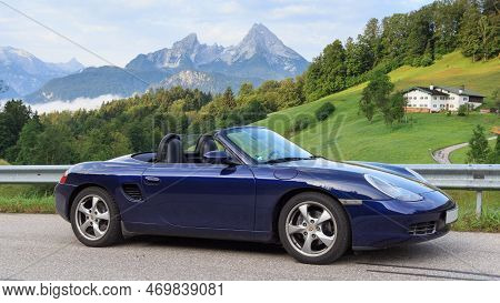 Berchtesgaden, Germany - July 25, 2021: Blue Roadster Porsche Boxster 986 With Mountain Watzmann And