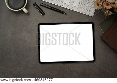 Top View Of Digital Tablet With Blank Screen, Cup Of Coffee And Notepad On Black Slate Texture Backg