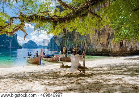 Women On A Swing At The Tropical Lagoon Of Koh Loa Lading Krabi Thailand Part Of Koh Hong Islands