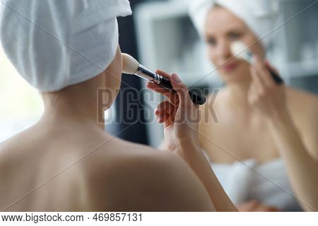 Young Woman Sits In The Bathroom In Front Of The Makeup Mirror And Does Cosmetic Procedures. Beautif