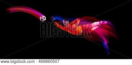 Sportive Energetic Man, Soccer Football Goalkeeper In Action, Motion Over Dark Background With Mixed
