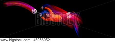 Sportive Energetic Man, Soccer Football Goalkeeper In Action, Motion Over Dark Background With Mixed