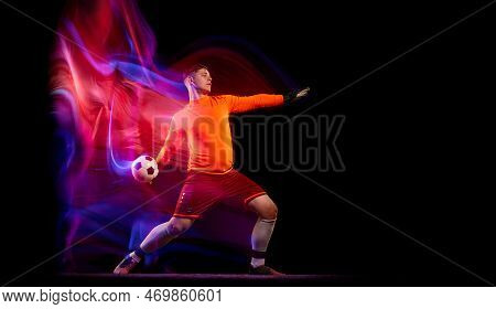 Sportive Energetic Man, Soccer Football Goalkeeper In Action, Motion Over Dark Background With Mixed