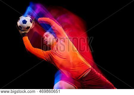 Sportive Energetic Man, Soccer Football Goalkeeper In Action, Motion Over Dark Background With Mixed