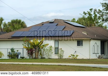 Aerial View Of Regular American Home Roof With Blue Solar Photovoltaic Panels For Producing Clean Ec