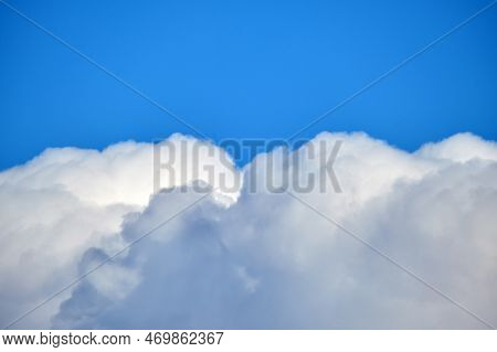 Bright Landscape Of White Puffy Cumulus Clouds On Blue Clear Sky.