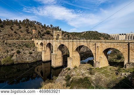 Roman Bridge Over The Tagus, Tajo River In Alcantara, Caceres Province, Extremadura, Spain. The Roma