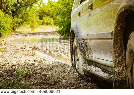 Close Up View 4wd Drive Wheel Spins Through Mud Isolated Stuck On Adventure Tour Outdoors