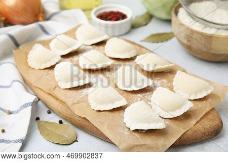 Raw Dumplings (varenyky) With Tasty Filling And Ingredients On Light Grey Table