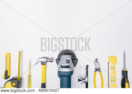 Top View Selective Focus Grinder And Construction Diy Tools On White Background.