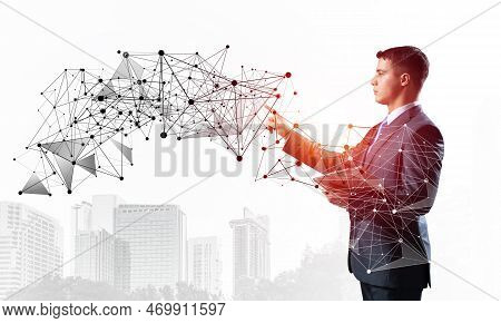 Business Person Pointing On Abstract Network Structure. Standing Personal Assistant In Business Suit