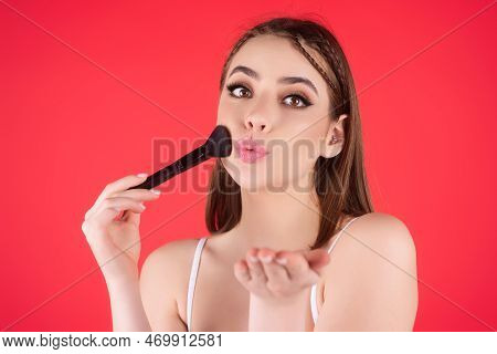 Young Woman Applies Powder On The Face Using Makeup Brush. Beautiful Girl Doing Contouring Apply Blu