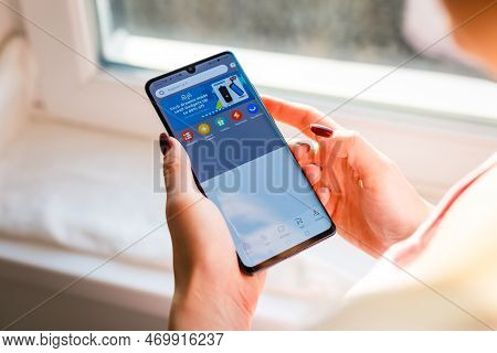 Kyiv, Ukraine - November 26, 2019: Woman Holding Phone With Internet Shopping Service Aliexpress On 