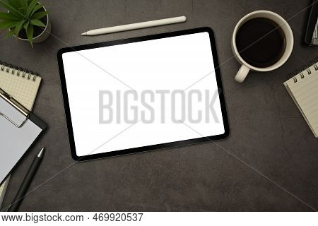 Flat Lay Digital Tablet With White Empty Display, Stylus Pen, Coffee Cup And Notepad On Black Slate 