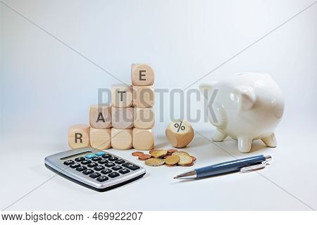 Calculate With Variable Interest, Wooden Cubes With The Word Rate And A Percent Sign, Piggy Bank, Ca