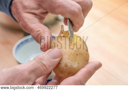 Hands Of An Elderly Man Peeling A Cooked Potato With A Kitchen Knife, Preparing Food, Copy Space, Se